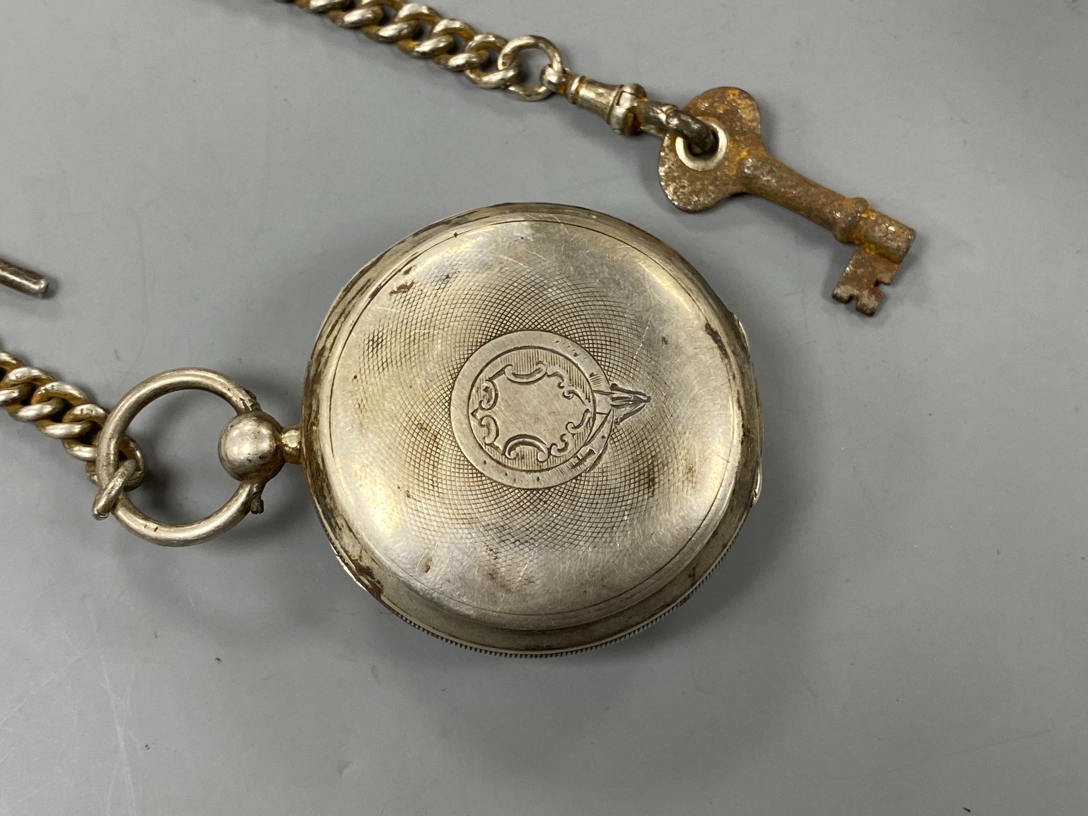 A late Victorian Waltham silver open faced key wind pocket watch, on a silver albert.